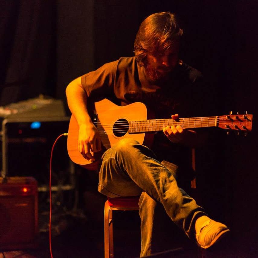 Andrés playing live guitar on stage